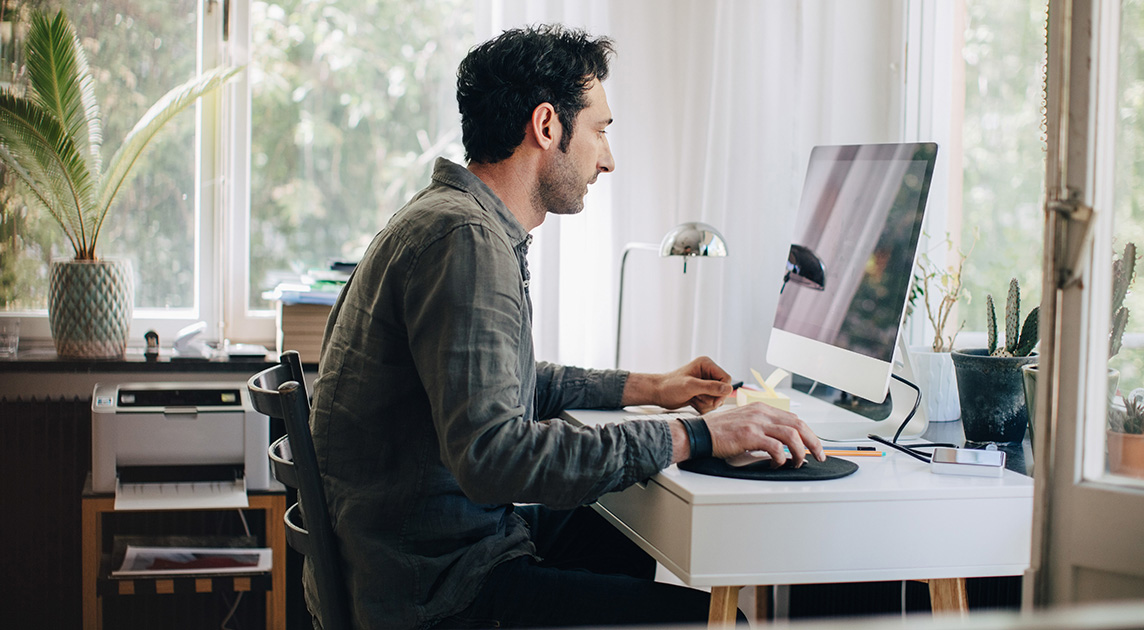 A Covered California member browses options on his computer.